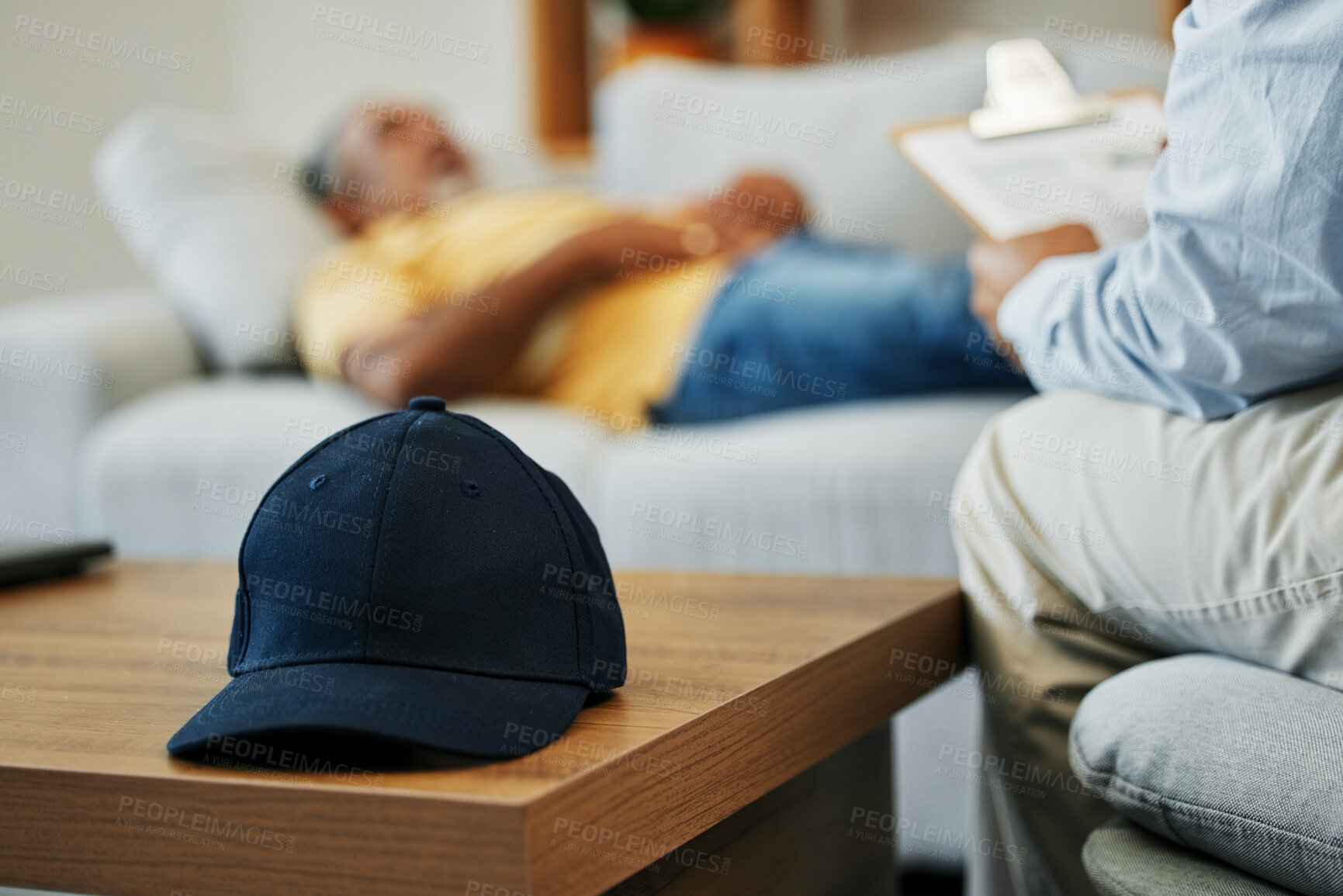 Buy stock photo Cap, help and man in therapy for stress, conversation and discussion about mental health. Anxiety, psychology and closeup of hat on table in counseling for advice, notes or support from psychologist