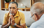 Stressed senior man talking to a psychologist at mental health, psychology and therapy clinic for session. Therapist with clipboard for counseling checklist with elderly male patient in modern office