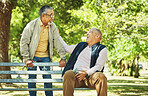 Elderly friends, laughing and relax at park bench, talking and bonding outdoor in retirement. Funny, smile and senior men sitting together in garden, communication and support to comfort in nature