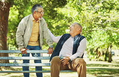 Buy stock photo Elderly friends, laughing and relax at park bench, talking and bonding outdoor in retirement. Funny, smile and senior men sitting together in garden, communication and support to comfort in nature