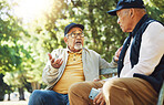 Senior friends, men and conversation on park bench, bonding and relax outdoor with phone. Elderly people sitting together in garden, communication and serious in nature for retirement in the morning