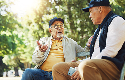 Buy stock photo Senior friends, men and conversation on park bench, bonding and relax outdoor with phone. Elderly people sitting together in garden, communication and serious in nature for retirement in the morning