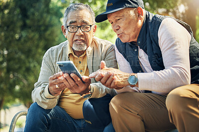 Buy stock photo Senior men, friends and phone in park, reading and talk with memory, thinking and relax in sunshine. Elderly people, smartphone and talking on bench, nostalgia and check social media notification