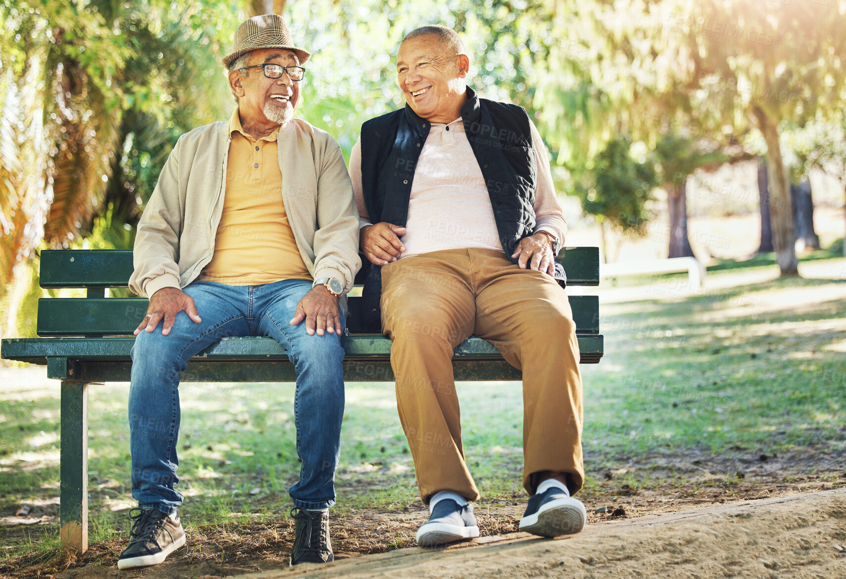 Buy stock photo Senior friends, men and smile at park bench, talking and bonding outdoor to relax. Happy elderly people sitting together in garden, communication and conversation in nature for retirement in spring