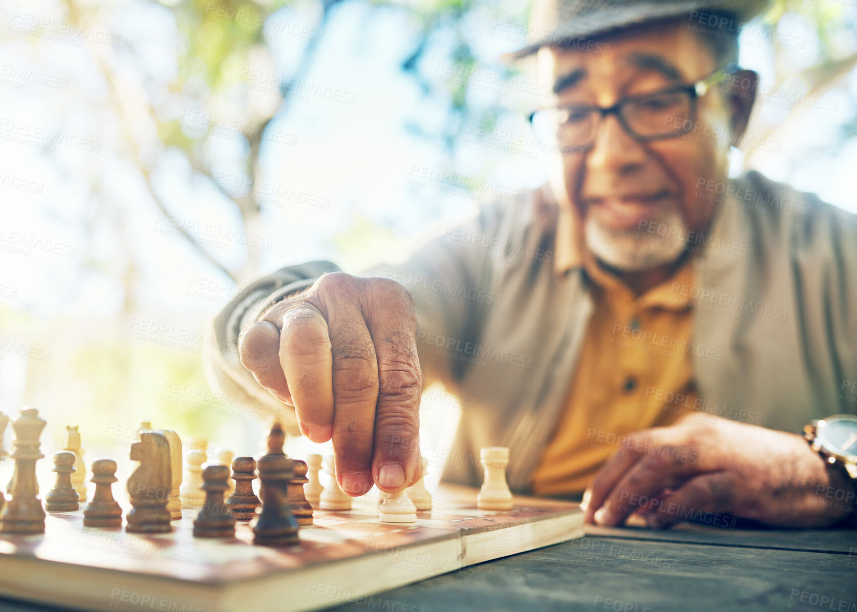 Buy stock photo Old man in park, hand with chess game and strategy, competition or challenge, retirement and moving piece. Closeup, planning and contest outdoor, concentration on boardgame and recreation in nature