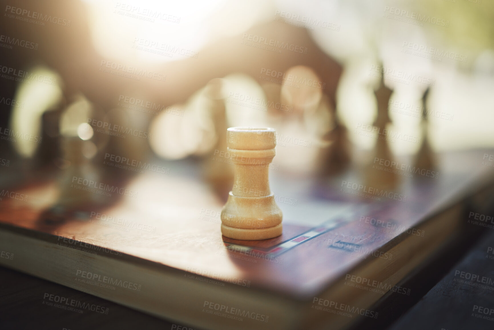 Buy stock photo Closeup, chess and hand at park for competition, strategy and moving silhouette in sunshine. Person, vintage board game and outdoor for contest, battle and problem solving with challenge in summer
