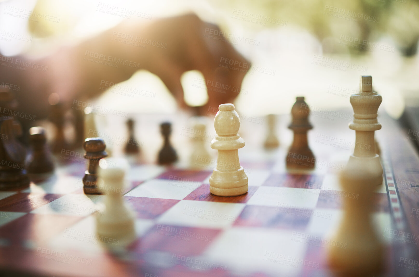 Buy stock photo Closeup, chess and hand at park for challenge, strategy and moving silhouette in sunshine. Person, vintage board game and outdoor for contest, battle and problem solving with competition in summer