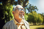 Happy, thinking and senior man in park, nature and outdoor adventure in retirement, holiday or vacation in sunshine. Elderly person, happiness and smile in summer, forest or woods with wellness