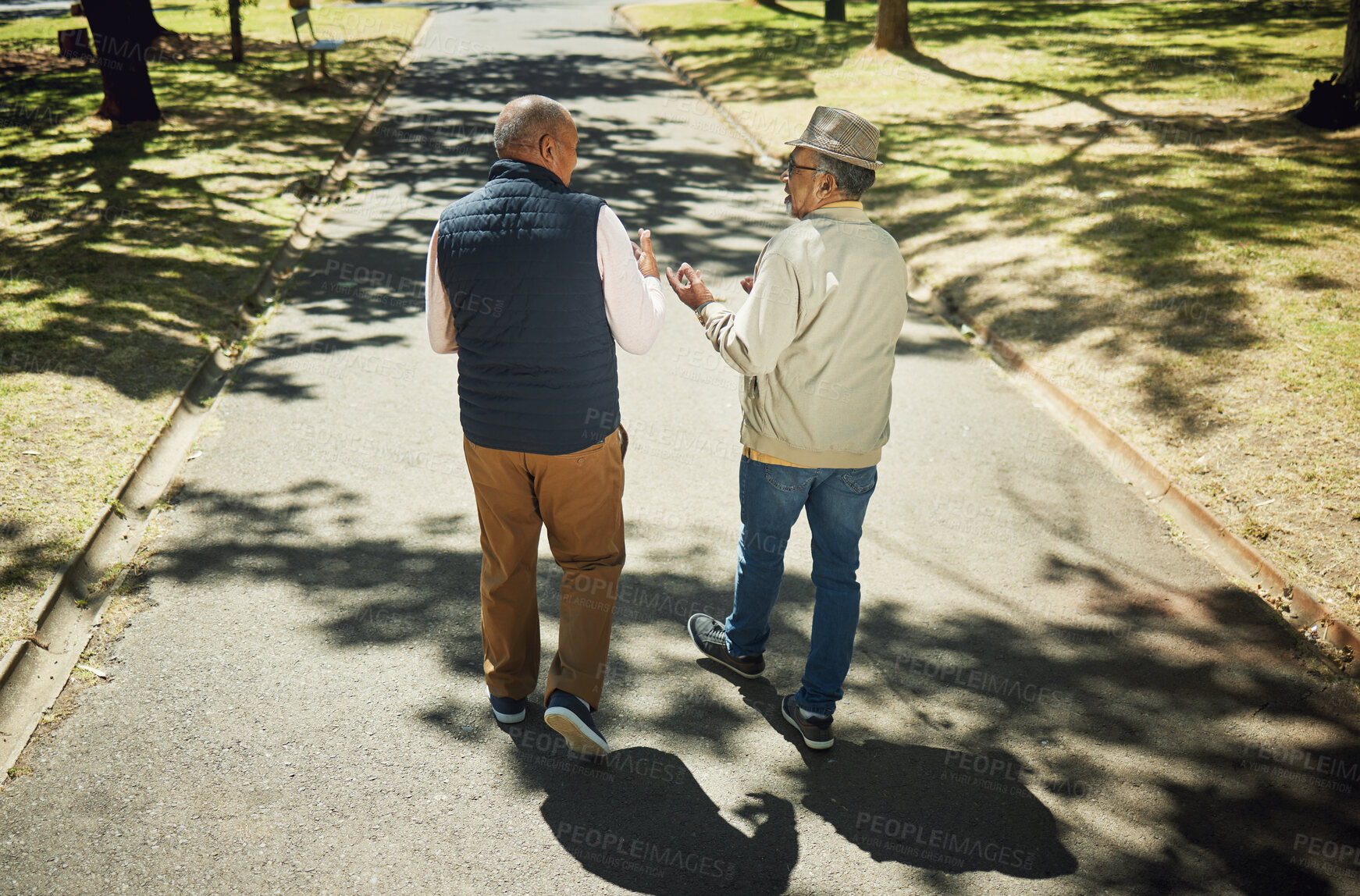 Buy stock photo Senior, friends walking and talking in park, nature and outdoor in retirement with support and communication. Elderly, men and behind people on path in New York with conversation and community