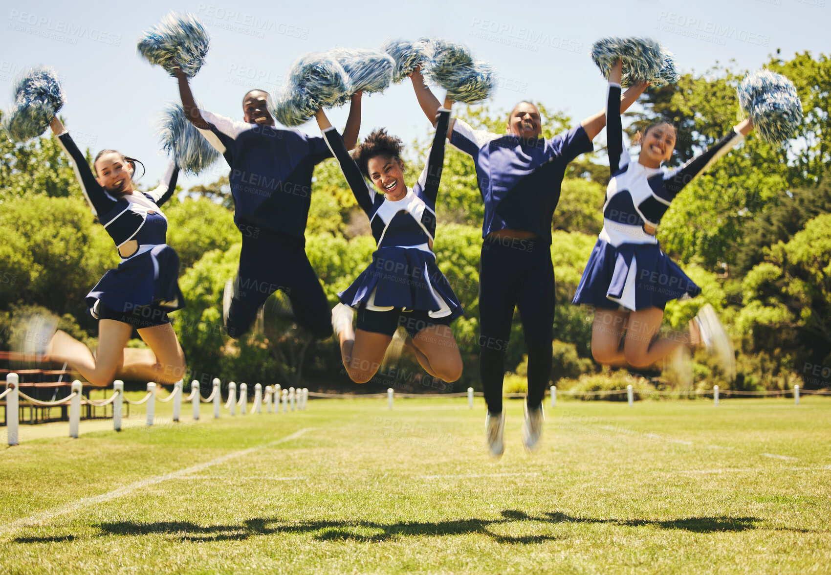 Buy stock photo Cheerleader team portrait, people and jump for performance on field outdoor in training, celebration or exercise. Happy, cheerleading group and energy for support at event, sport competition and blur