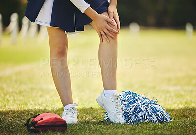 Buy stock photo Cheerleader, injury and person with knee pain from sport, training and cheer exercise on a grass field. Health, accident and leg muscle bruise outdoor with emergency or workout challenge for wellness