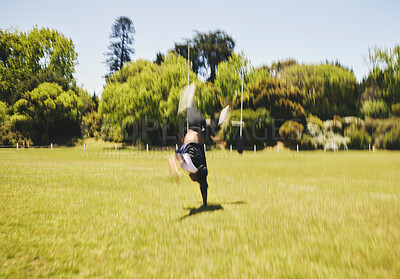 Buy stock photo Cheerleader, blur and cartwheel on field for performance, dance and training outdoor. Cheerleading, moving and energy for workout, motion and fast at event for sport competition, game and acrobat