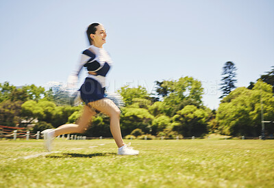 Buy stock photo Fitness, cheerleader and woman running on a field for match motivation, energy or performance. Sports, runner and cheerleading female with freedom at a park for game training, practice or competition