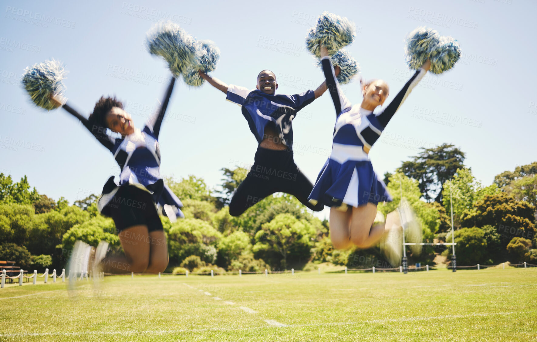 Buy stock photo Cheerleader team, smile and people jump for performance on field outdoor in training, celebration or exercise. Happy, cheerleading group and energy for support at event, sport competition and blur