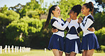 Group, hug or happy cheerleader with women outdoor in training or sports event together. Teamwork, smile or proud girl by an excited cheer squad on field for support, winning celebration or fitness