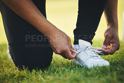 Buy stock photo Person, hand and shoes for competition in sports on field for workout, practice or game in closeup. Athlete, dedication or tie lace on track for race by commitment in tournament, performance or match