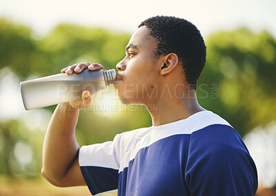 Buy stock photo Nature, relax or black man drinking water on break after exercise, workout or fitness training in park. Profile, healthy or thirsty African sports athlete with liquid bottle for wellness or hydration