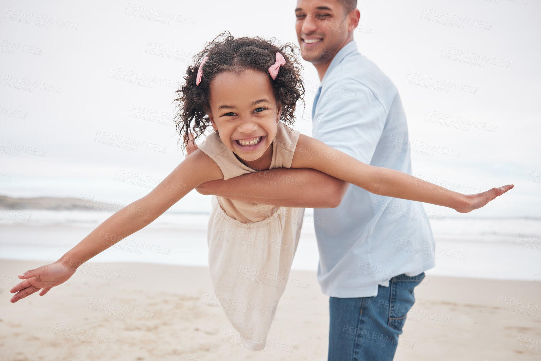 Buy stock photo Dad, daughter and beach while playing, airplane and smiling for fun, excitement and happiness on vacation, holiday and memories. Freedom, fly and joy with blue skies, outdoor and bonding together