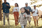 Park, running and girl with parents or grandparents on grass field for freedom, adventure or playing in summer. Family, men or women with fun or love in forest with sunshine for care or happiness