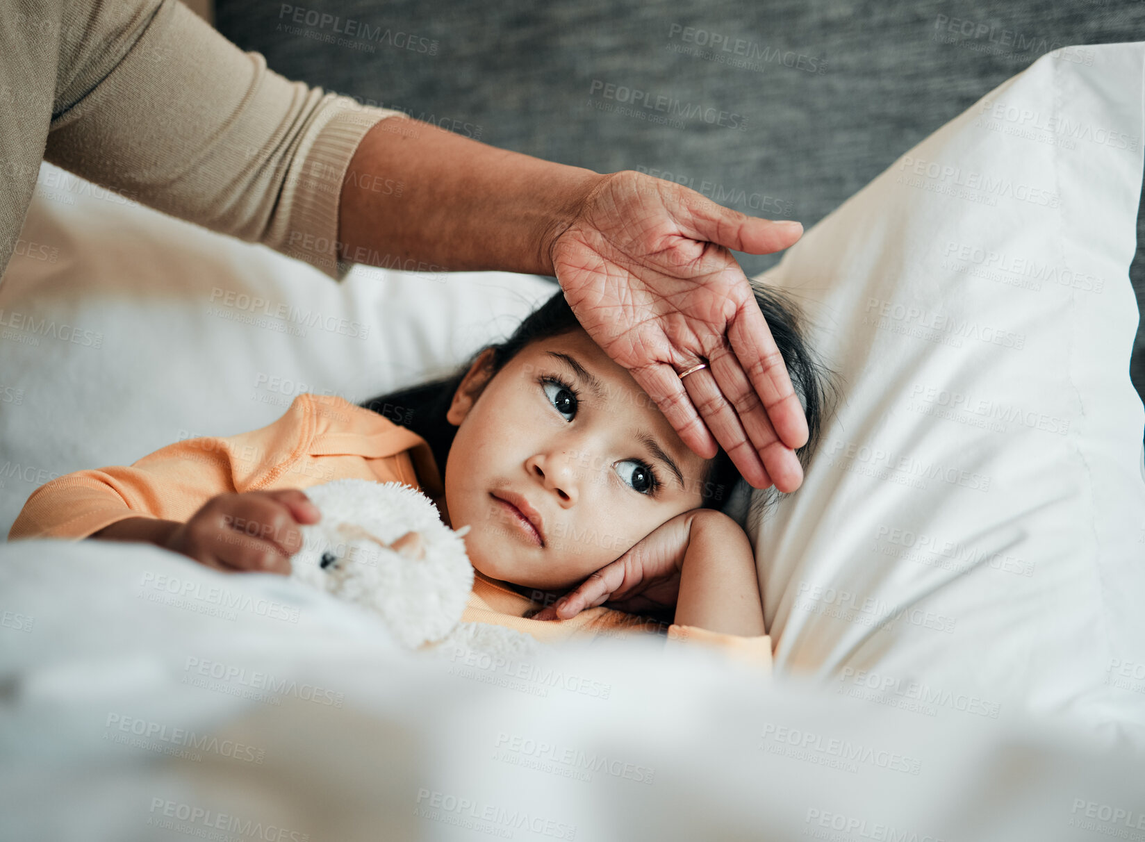 Buy stock photo Girl kid, check for fever and sick in bed with hand on head, health and wellness, parent monitor temperature at home. Headache, illness and young child with the flu, medical help and support of mom