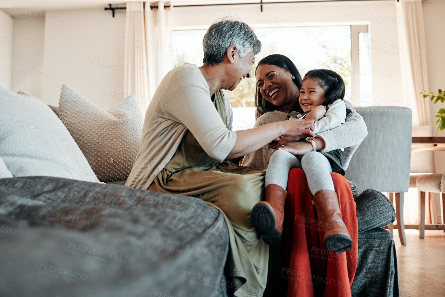 Buy stock photo Happy, playful and family on sofa for a visit, conversation and bonding in a house. Smile, living room and a senior person, mother and girl kid for love, care and communication together on the couch