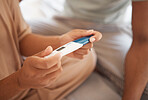 Pregnancy test, closeup and hands of couple in their house with results, news or expectation.Pregnant, love and zoom on man with woman checking home testing kit for family planning or ivf success