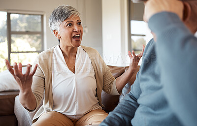 Buy stock photo Divorce, fight and senior couple on a sofa angry, shouting and frustrated in their home together. Marriage, crisis and elderly people in a living room argue, stress and anxiety for debt, risk or liar