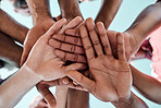 People, teamwork and hands together in motivation, collaboration or community for goals below. Closeup of group piling in team building, solidarity or trust in support for sports, rugby or match