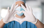 Male doctor, hands and heart in closeup with thank you for support and trust with healthcare. Medical professional, love and care or hope, help and zoom in emoji for gratitude by blurred background
