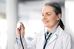 Senior woman, doctor and healthcare with stethoscope, smile and appointment with career success. Mature person, medical professional and happy employee with hospital equipment, worker and medicare