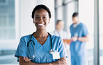 Smile, nurse and portrait of black woman with arms crossed in hospital for healthcare, wellness and nursing career. Face of happy African surgeon, confident medical professional worker and employee