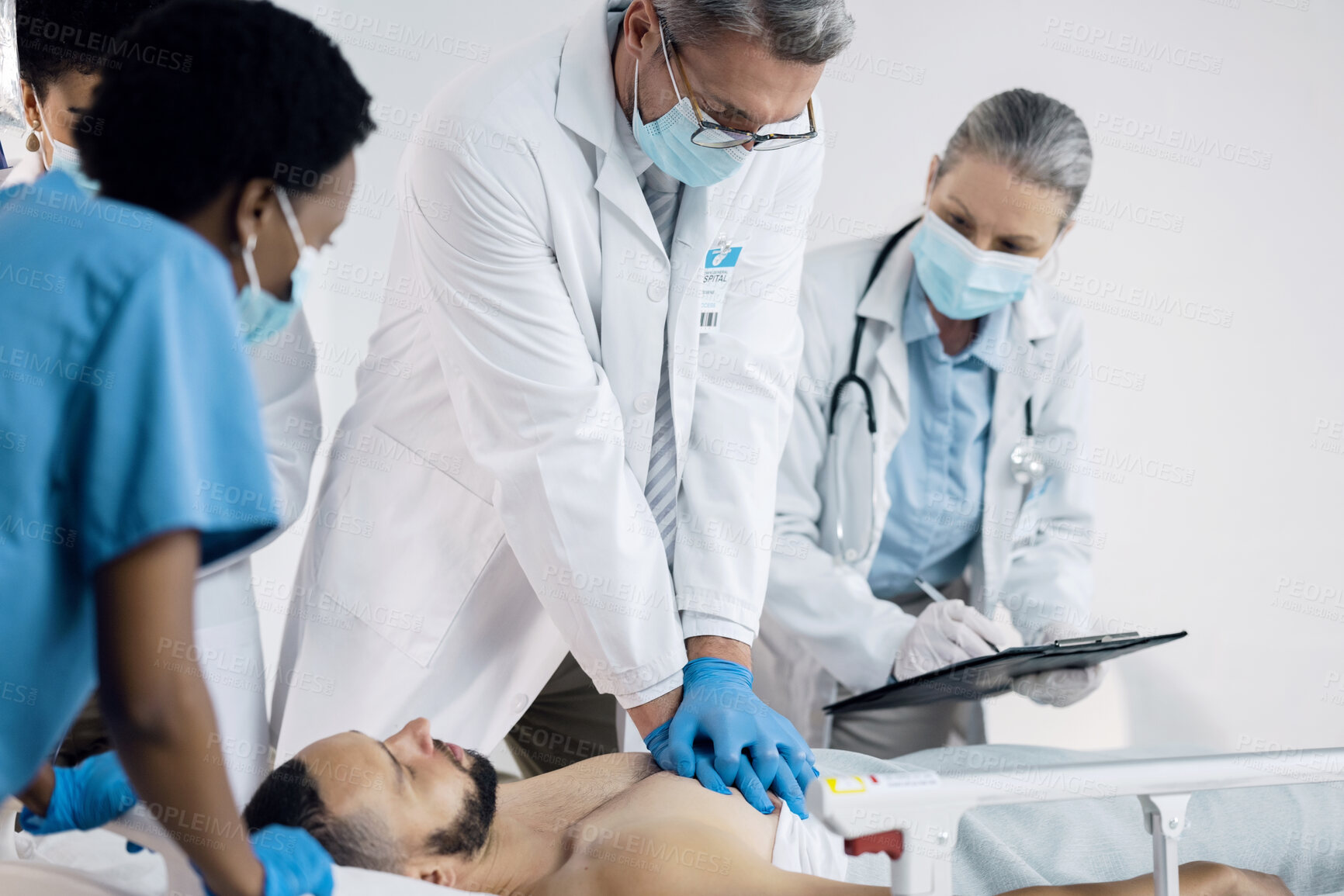 Buy stock photo CPR, emergency and doctor with patient in hospital for medical service, first aid and surgery. Healthcare, teamwork and man do chest compressions for injury, serious accident and wellness in clinic