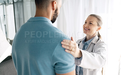 Buy stock photo Doctor, patient and woman touch shoulder for support in consultation for healthcare, wellness or empathy. Happy medical professional comfort man for care, kindness and mature surgeon help in hospital