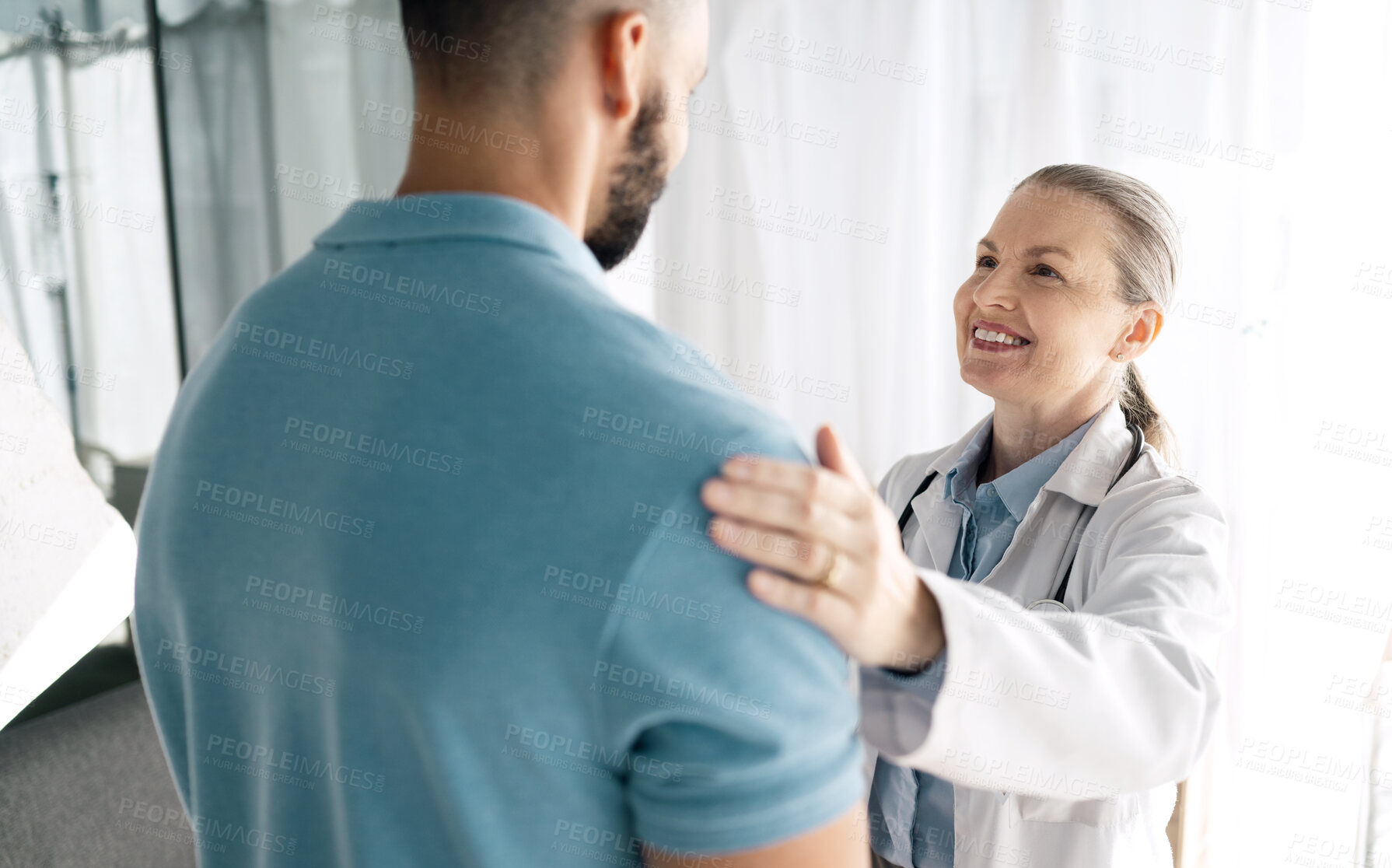 Buy stock photo Doctor, patient and woman touch shoulder for support in consultation for healthcare, wellness or empathy. Happy medical professional comfort man for care, kindness and mature surgeon help in hospital