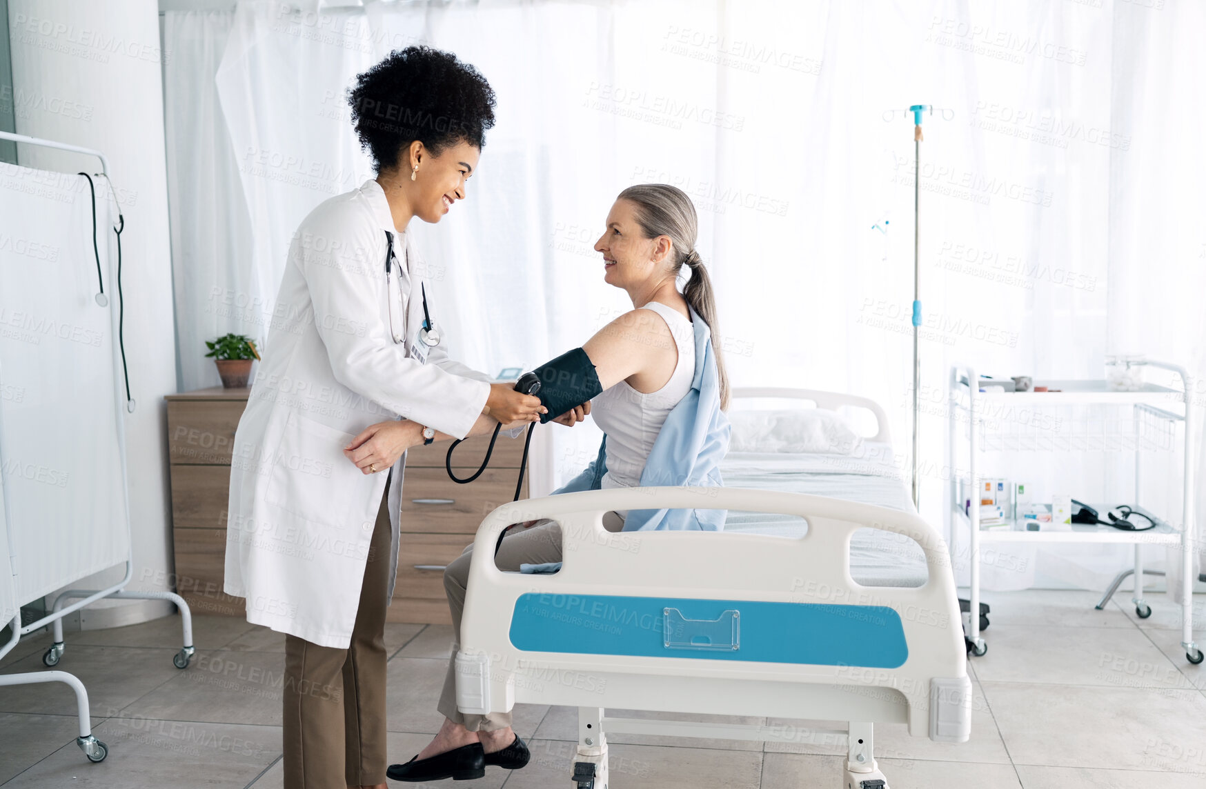 Buy stock photo Clinic patient, happy people and doctor hypertension test for medical exam, assessment or professional service. Medicine expert, sphygmomanometer and nurse monitor blood pressure, pulse or wellness