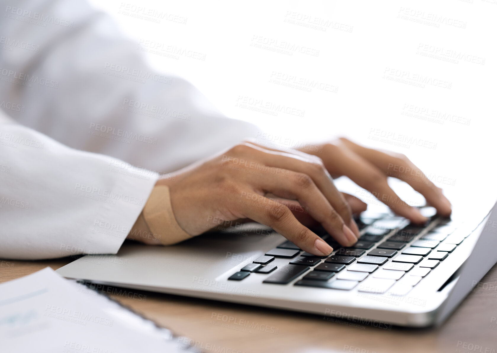 Buy stock photo Closeup, hands and doctor with a laptop, typing and connection with research, network and website info. Person, medical professional and worker with plaster, pc and keyboard with deadline and app