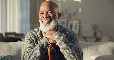 Happy, face and a black man with a cane on the sofa for support, medical help and retirement. Smile, house and portrait of a senior African person on the living room couch with a stick for walking