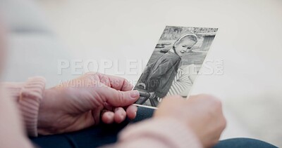 Senior woman, holding and photo with memory with hands and remembering a child in closeup. Retirement, history and elderly person with retro picture in home with nostalgia or thinking about past.