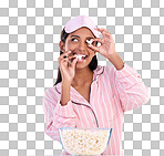Popcorn, pajamas and playful with a woman on a blue background in studio watching a movie for entertainment. Fun, video and night with an attractive young female eating a snack while streaming
