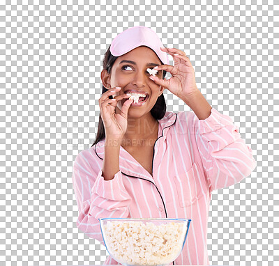 Popcorn, pajamas and playful with a woman on a blue background in studio watching a movie for entertainment. Fun, video and night with an attractive young female eating a snack while streaming
