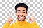 Pointing up, excited and portrait of Asian man on blue backgroun