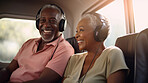 Senior couple listen to music with headphones on vacation on sunny day, beach vacation or retirement