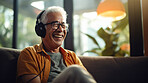 Senior man listen to music with headphones on vacation on sunny day, beach vacation or retirement