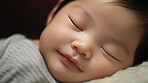 Closeup of sleeping newborn boy baby. Portrait of baby wrapped in blanket