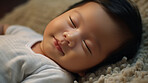 Closeup of sleeping newborn boy baby. Portrait of baby wrapped in blanket