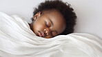 Closeup of sleeping newborn girl baby. Portrait of baby wrapped in blanket