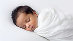 Closeup of sleeping newborn boy baby. Portrait of baby wrapped in blanket