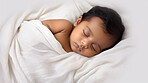 Closeup of sleeping newborn boy baby. Portrait of baby wrapped in blanket