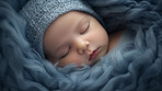 Closeup of sleeping newborn boy baby. Portrait of baby wrapped in blanket