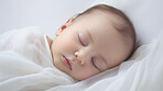 Closeup of sleeping newborn girl baby. Portrait of baby wrapped in blanket